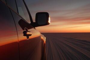 Sunset drive along a white salt flat with reflections on the car's surface photo