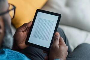 Reading a digital book in a cozy living room during a quiet afternoon photo
