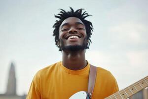 Smiling musician playing guitar against a cloudy sky in an urban setting during late afternoon photo
