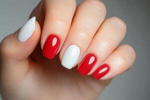 Creative nail art featuring red and white polish with a modern design suitable for various occasions photo