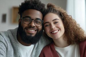 Happy couple poses for a close-up portrait at home during a cozy afternoon moment photo