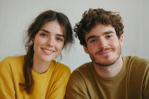 Warm smiles of a young couple enjoying a casual moment together in a cozy indoor setting photo