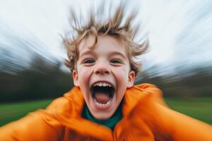 Joyful child running outdoors with wind-blown hair in a vibrant orange coat on a cloudy day,motion blur photo