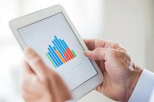 Analyzing data trends on a tablet in a bright office environment during a working day photo