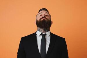 Confident man with tattooed neck dressed in formal suit against bright orange background photo