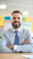 Professional man with beard smiles confidently in a brightly colored classroom setting during the day photo