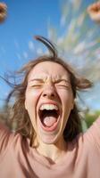 Joyful woman celebrating outdoors with excitement and energy on a sunny day in the park photo