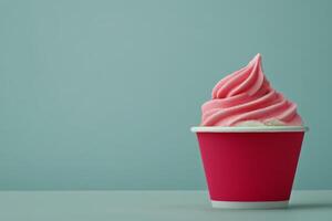 Delicious pink soft serve ice cream in a pink cup against a simple backdrop photo