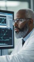 Scientist analyzing data on computer in laboratory during daytime, demonstrating focus and expertise in research photo