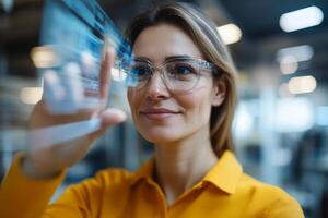 Woman interacts with digital display in modern office environment during daytime photo