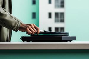 Person enjoying vinyl records while using a turntable in a modern indoor space during daylight hours photo