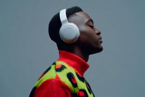 Young man enjoying music while wearing headphones in a studio setting with vibrant colors and patterns photo