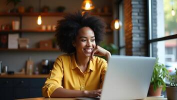 Young African American hipster woman with Afro hair looks at webcam while talking to friend online sits at cafe table making call virtual chat recording blog posing for heads Realistic Set photo