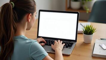 Flat Hipster teen girl student sitting at kitchen table using laptop computer touchpad mock up white blank monitor screen learning online on modern notebook working from home offic Realistic Set photo
