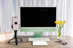 Prague, Czech republic - February 24, 2025. Work place with iMac and iPhone with open Chat Gpt application on screen. Work assistant with Open Ai. Artificial Intelligence concept. High quality photo