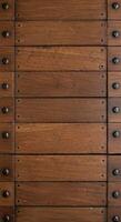 Stacked antique wooden drawer fronts with visible wear and metal accents photo