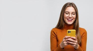 Smiling young woman with long hair looking at her mobile phone photo