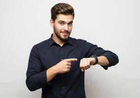 Guy checking the time on his smartwatch, isolated on a white background photo