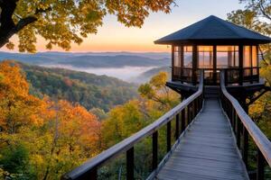 Wooden walkway leading to octagonal gazebo overlooking misty valley at sunrise in Brown County State Park photo