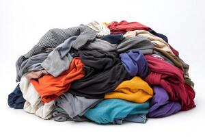 Pile of colorful clothes forming a chaotic mound on white background photo
