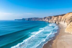Ocean waves crashing on the shore of a deserted beach next to high cliffs in Oman photo