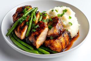Sliced grilled chicken breast with green beans and mashed potatoes garnished with chives photo