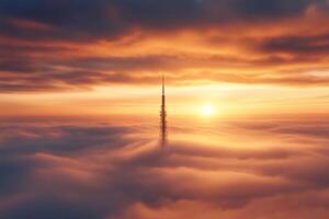 Riga Radio and TV Tower emerging from fog at sunset, aerial view photo