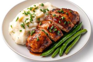 Sliced balsamic chicken breast with mashed potatoes and green beans garnished with chives photo