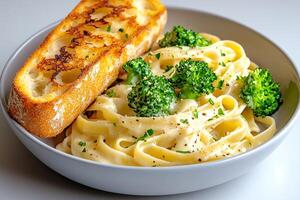 Creamy pasta with broccoli and toasted bread seasoned with parsley and pepper photo