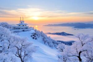 Sunrise illuminating snow covered trees and mountain top restaurant in Japan photo