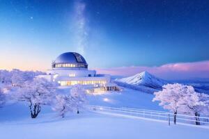 Snow covered astronomical observatory exploring milky way in winter wonderland at dawn photo