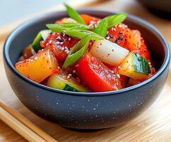 Oi muchim, refreshing korean cucumber salad with gochujang paste, enjoying a healthy vegan meal photo