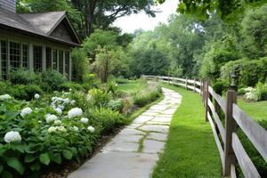 Winding stone path leading to beautiful house in lush green garden photo
