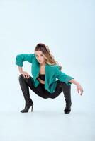 Young woman in green jacket and black boots isolated on white background. photo