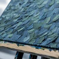A painting on an easel with blue paint photo