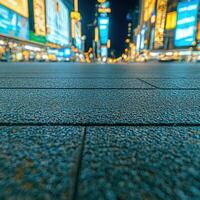 A city street at night with a city skyline in the background photo