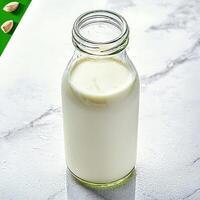 Almond milk in a glass bottle photo