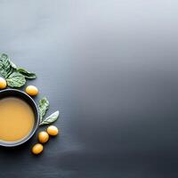 Bowl of fresh soup garnished with oranges and basil leaves for a colorful and healthy meal photo