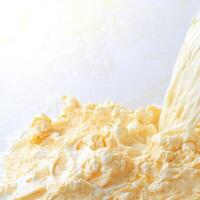 A person pouring milk into a bowl of cream photo