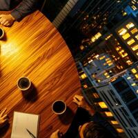 A group of people sitting around a table with coffee and pens photo
