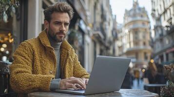 Businessman Working on Laptop Outdoors in Urban Setting with Modern Architecture photo