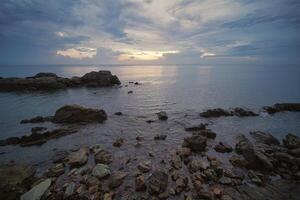 Sunset at the beach on a cloudy day photo