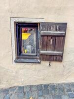 Old small Window with Wooden Shutter Open, Stone Wall, Historic Architecture, Street View. High quality photo