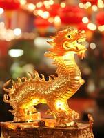 Golden dragon statue on a table in front of red lanterns photo