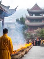 A monk is standing in front of a large fire photo