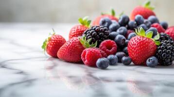 berries on marble table with copy space. strawberries, raspberries, blueberries, blackberries photo