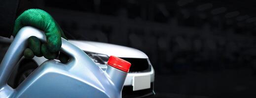 Auto mechanic holding oil container in auto repair garage , Oil change in car service , horizontal banner with copy space for text decoration , Car maintenance concept photo