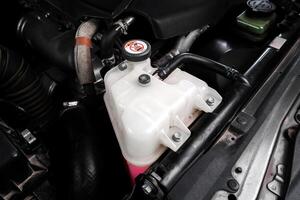 Close-up of coolant reservoir of car radiator , Automotive parts concept photo