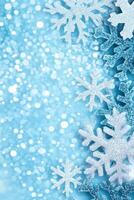 Sparkling Silver Snowflakes on a Light Blue Glittering Background photo