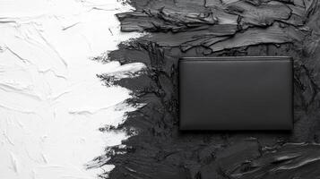 Elegant Black Wallet Against Contrasting Textured Background photo